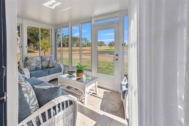 sunroom / solarium with a water view