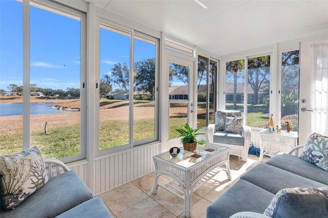 sunroom featuring a water view