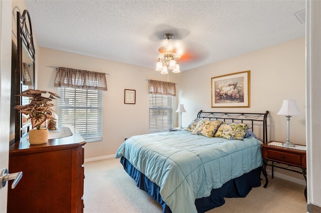 carpeted bedroom with a textured ceiling and ceiling fan