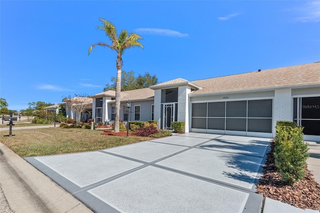 ranch-style home with a garage and a front yard