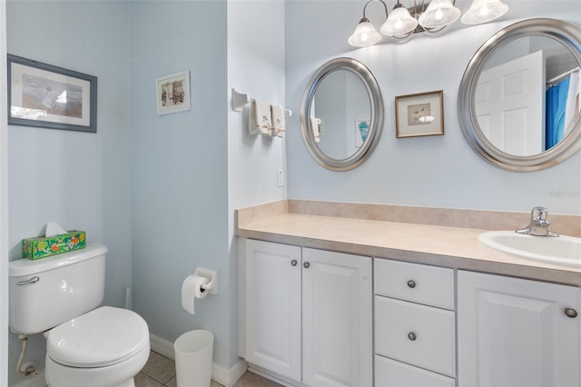 bathroom with vanity, tile patterned floors, and toilet