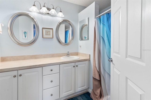 bathroom with vanity and a textured ceiling