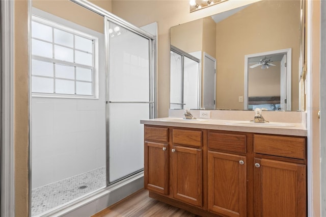 bathroom with ceiling fan, an enclosed shower, wood-type flooring, and vanity