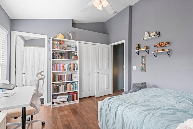 bedroom with a closet, vaulted ceiling, ceiling fan, and dark wood-type flooring