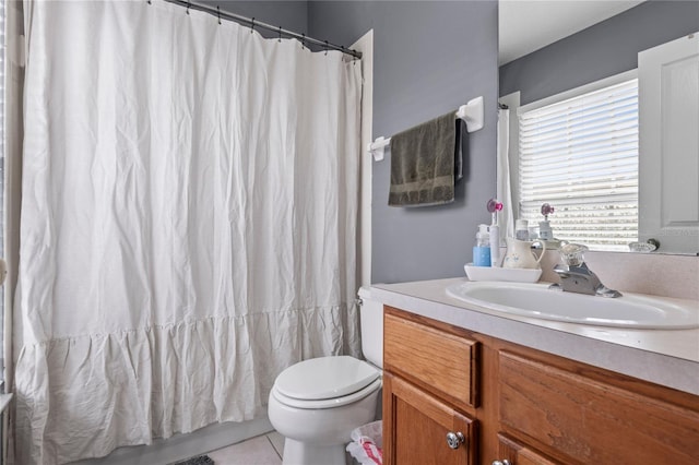 bathroom featuring toilet, vanity, and tile patterned floors