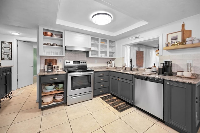 kitchen featuring appliances with stainless steel finishes, backsplash, light tile patterned floors, gray cabinets, and white cabinetry