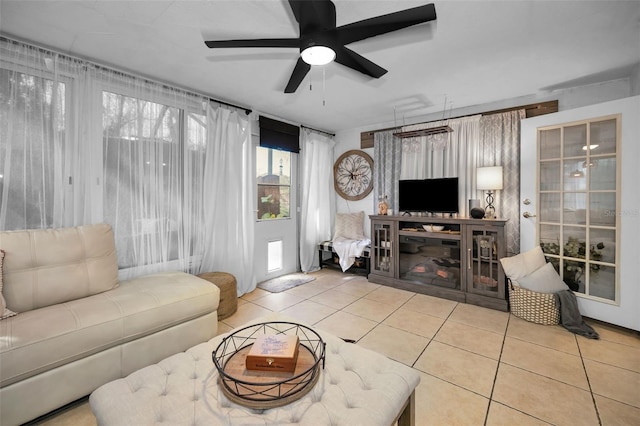 tiled living room featuring ceiling fan