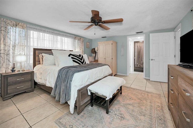 tiled bedroom featuring ceiling fan