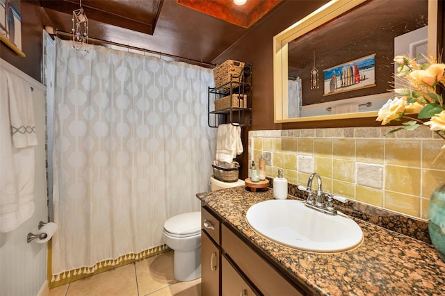 bathroom with toilet, vanity, backsplash, and tile patterned floors