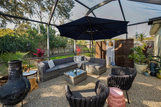 view of patio featuring glass enclosure and an outdoor living space