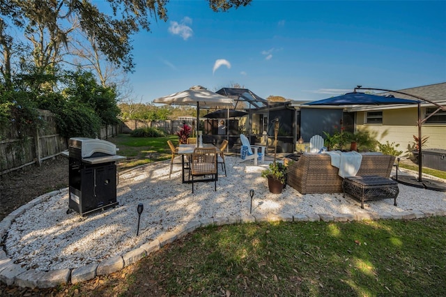 view of patio featuring area for grilling and glass enclosure