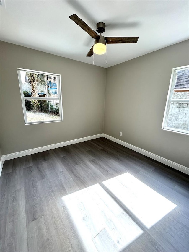 empty room with hardwood / wood-style floors and ceiling fan