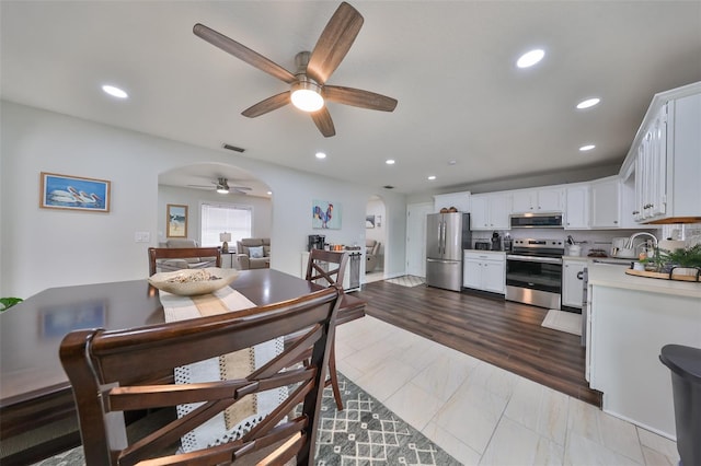 dining area featuring ceiling fan, light hardwood / wood-style floors, and sink