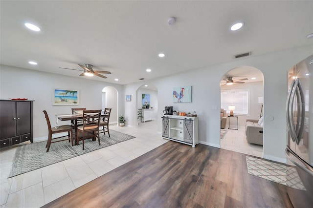 dining space featuring ceiling fan and light tile patterned flooring