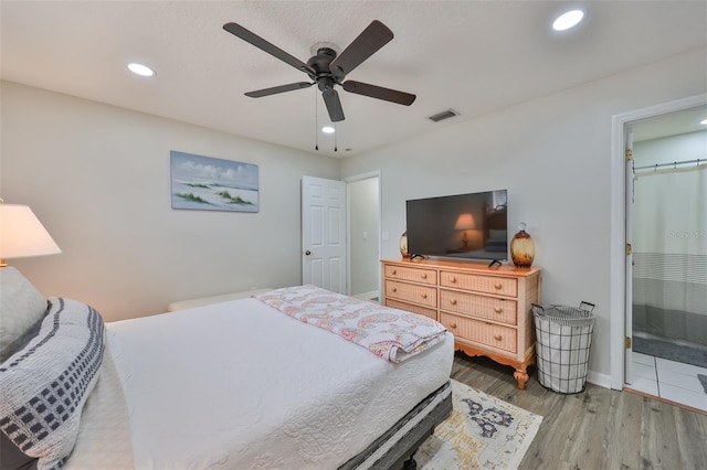 bedroom featuring a walk in closet, ceiling fan, hardwood / wood-style floors, connected bathroom, and a closet