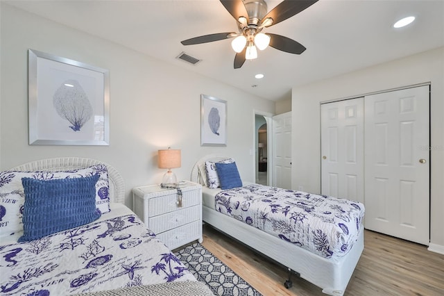 bedroom featuring wood-type flooring, a closet, and ceiling fan