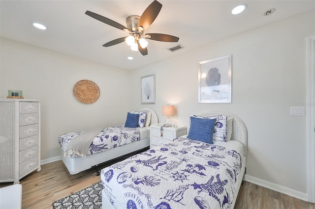 bedroom with ceiling fan and light wood-type flooring