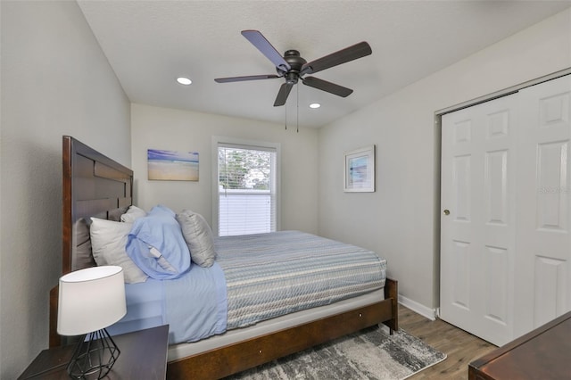 bedroom featuring ceiling fan, a closet, and dark hardwood / wood-style floors