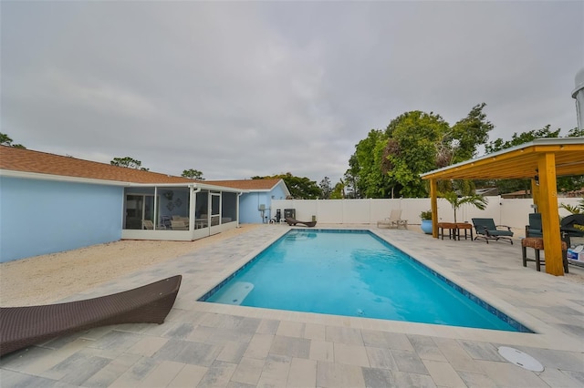 view of swimming pool with a patio area and a sunroom