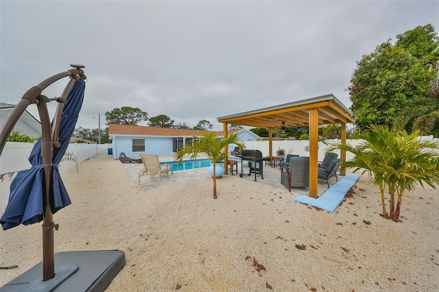 view of jungle gym featuring a fenced in pool, a patio area, and an outdoor living space