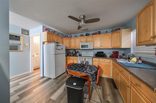 kitchen featuring a textured ceiling, white appliances, hardwood / wood-style flooring, and ceiling fan