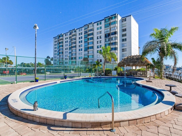 view of swimming pool with a gazebo and tennis court