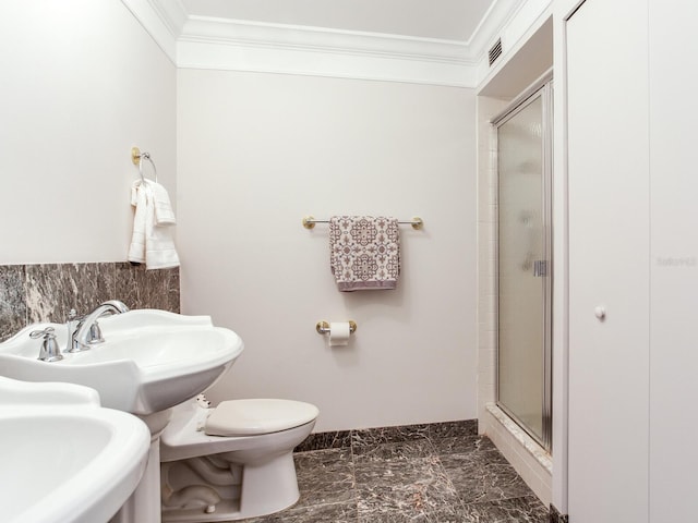 bathroom with toilet, walk in shower, ornamental molding, and sink