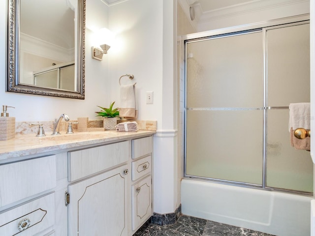 bathroom with vanity, enclosed tub / shower combo, and crown molding