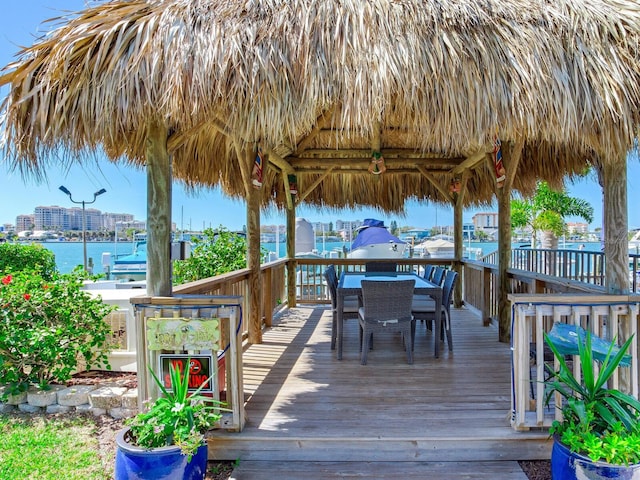 wooden terrace featuring a gazebo and a water view