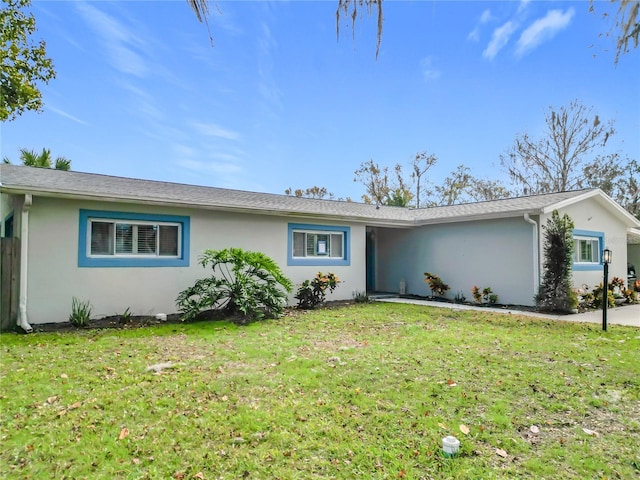 ranch-style home with a front lawn