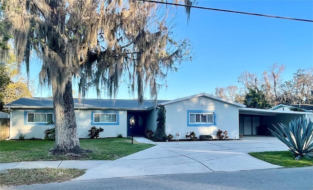 ranch-style home with a carport and a front yard