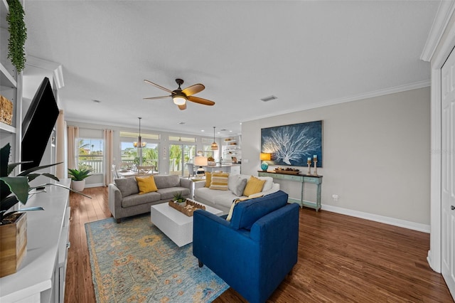 living room with crown molding, ceiling fan, and dark wood-type flooring