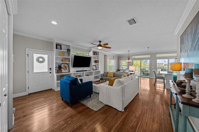 living room featuring hardwood / wood-style flooring, ceiling fan, and crown molding