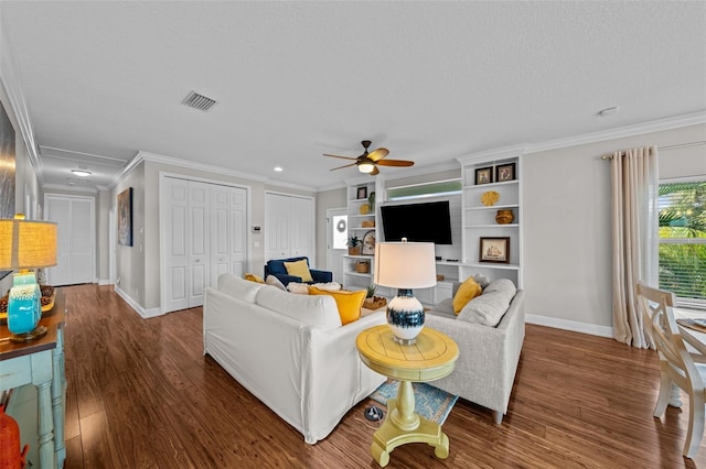 living room featuring ceiling fan, dark wood-type flooring, a textured ceiling, and ornamental molding