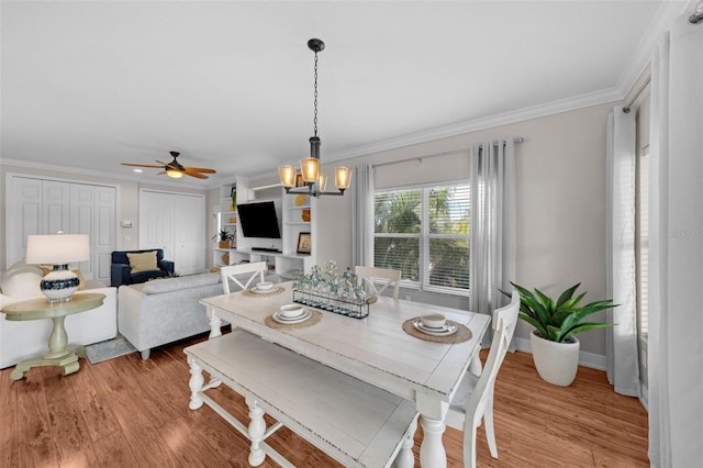 dining area featuring light hardwood / wood-style flooring, ceiling fan with notable chandelier, and ornamental molding