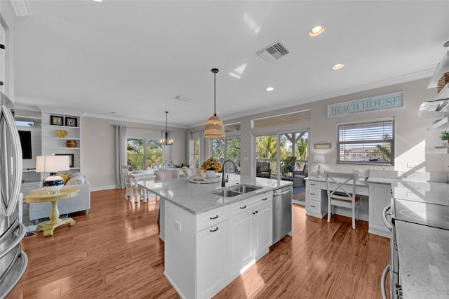 kitchen featuring light stone counters, sink, a center island with sink, dishwasher, and white cabinets