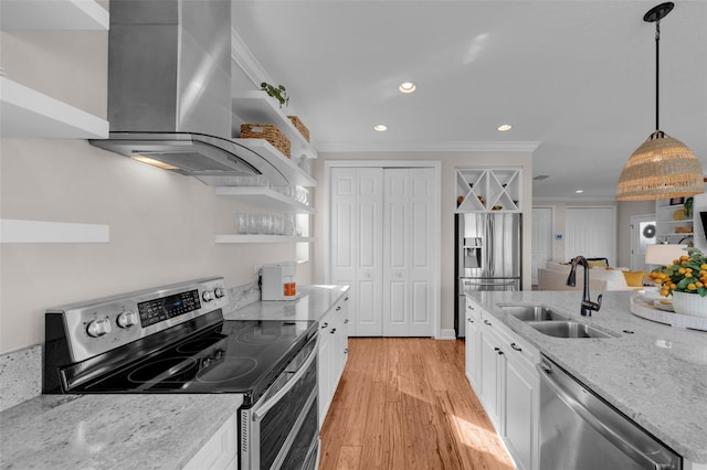 kitchen featuring white cabinets, light stone counters, wall chimney range hood, and stainless steel appliances