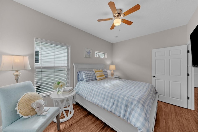 bedroom featuring hardwood / wood-style flooring and ceiling fan