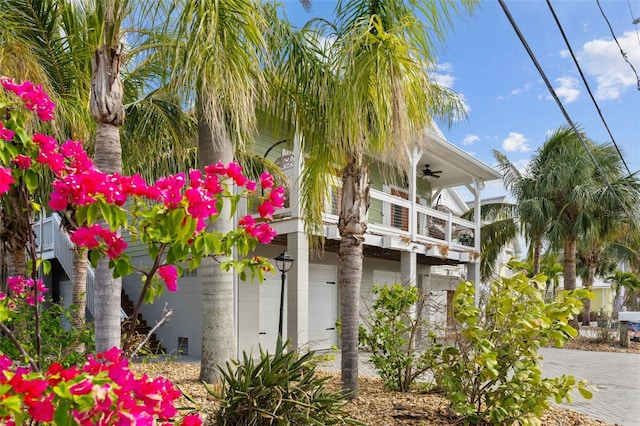 view of home's exterior with a balcony, a garage, and ceiling fan