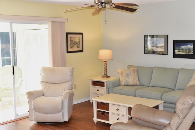 living room with ceiling fan, plenty of natural light, and dark hardwood / wood-style flooring