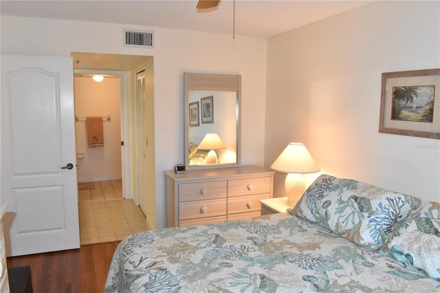 bedroom with ceiling fan, a closet, and dark wood-type flooring