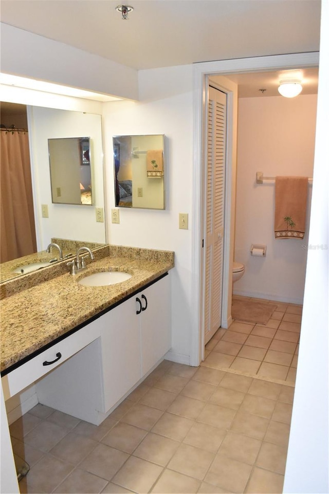 bathroom with tile patterned floors, toilet, and vanity