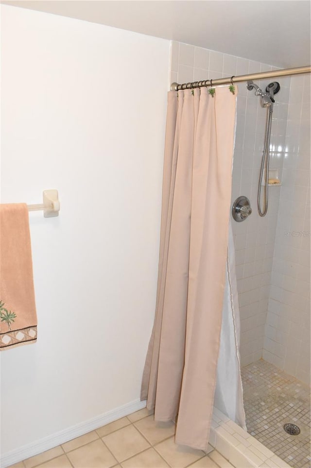 bathroom with walk in shower and tile patterned flooring