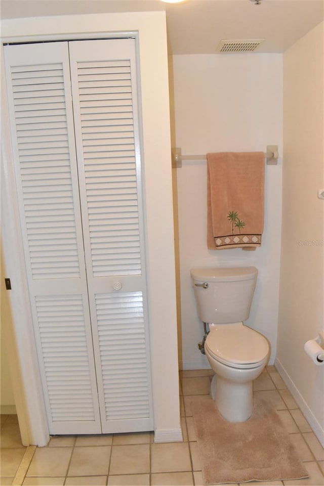 bathroom featuring toilet and tile patterned flooring