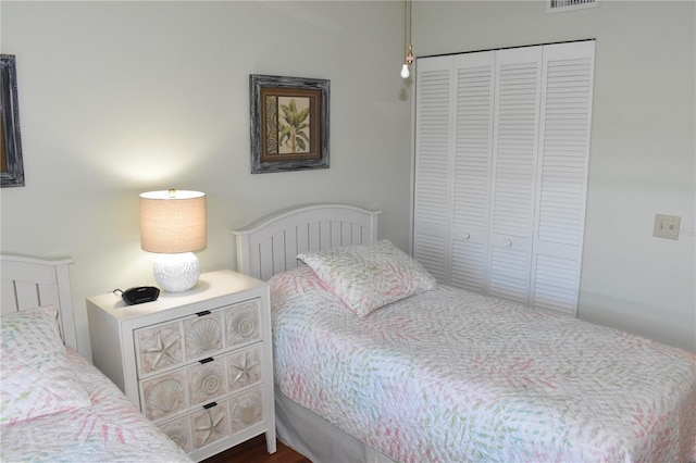 bedroom featuring dark wood-type flooring and a closet