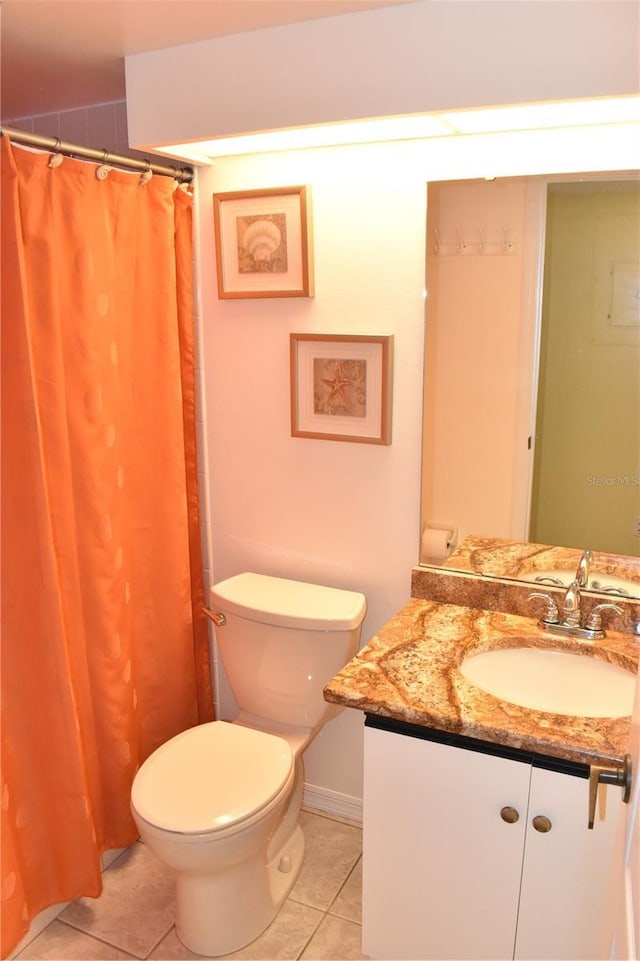 bathroom featuring tile patterned floors, vanity, and toilet