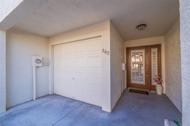 doorway to property with a garage