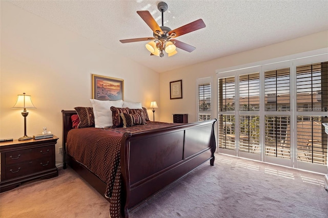 bedroom featuring a textured ceiling, ceiling fan, light carpet, and lofted ceiling