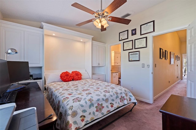 carpeted bedroom with ensuite bathroom, ceiling fan, and lofted ceiling