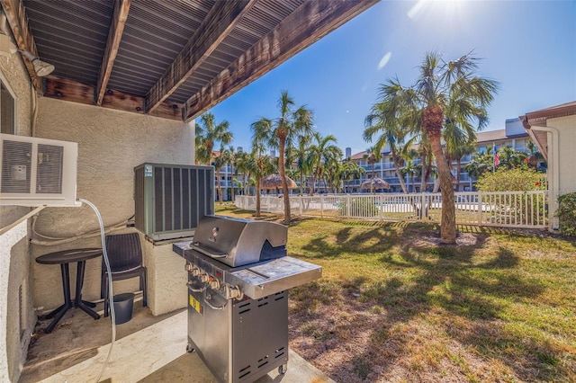 view of patio with central air condition unit and a grill